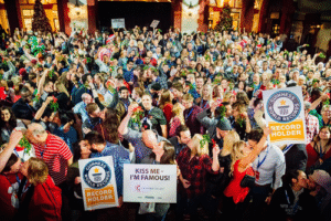 Most Couples Kissing Under Mistletoe in Festive Celebration